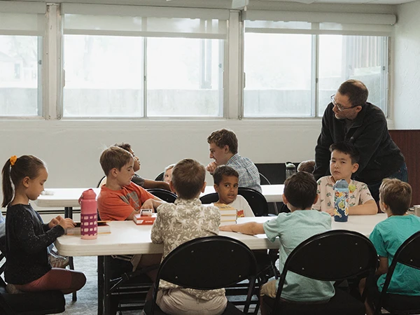 A group of kids hanging out on the sidewalk A group of kids hanging out on the sidewalk