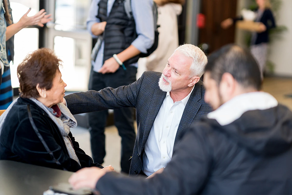 Women helping children at a registration table. Women helping children at a registration table.