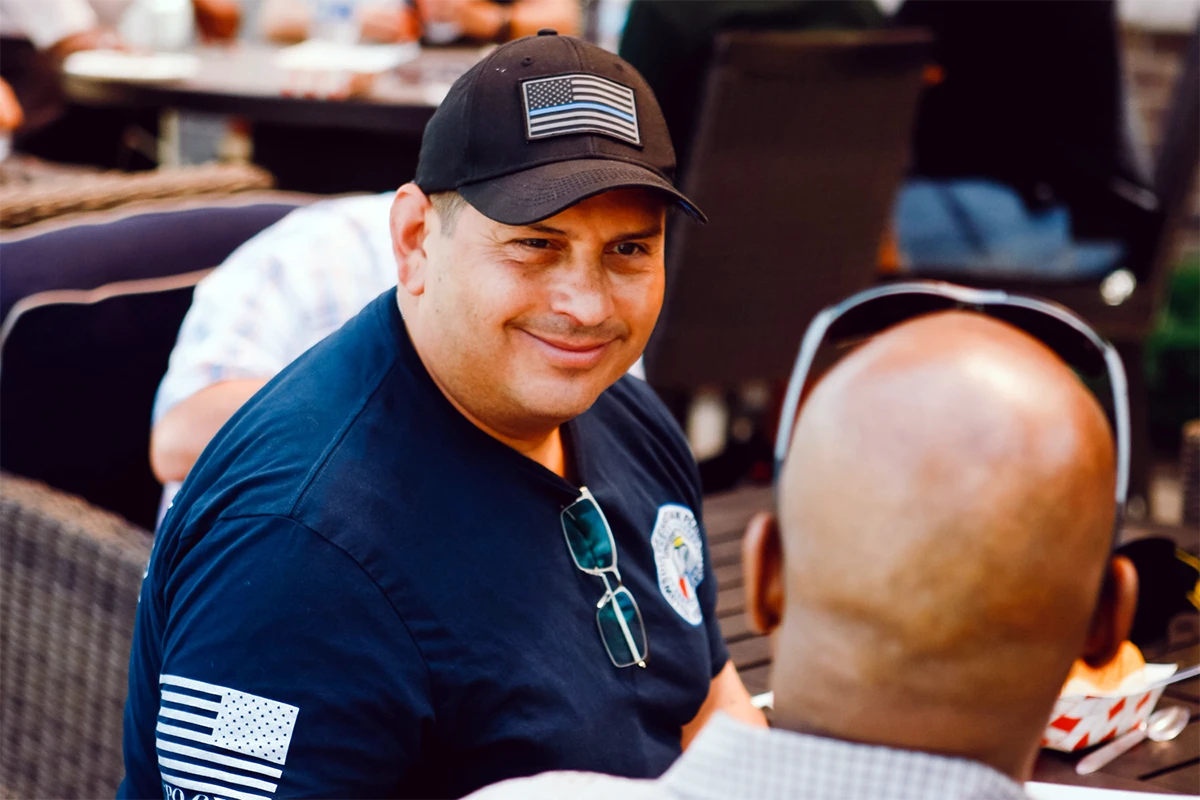 Gentlemen looking away talking with a firefighter. Gentlemen looking away talking with a firefighter.
