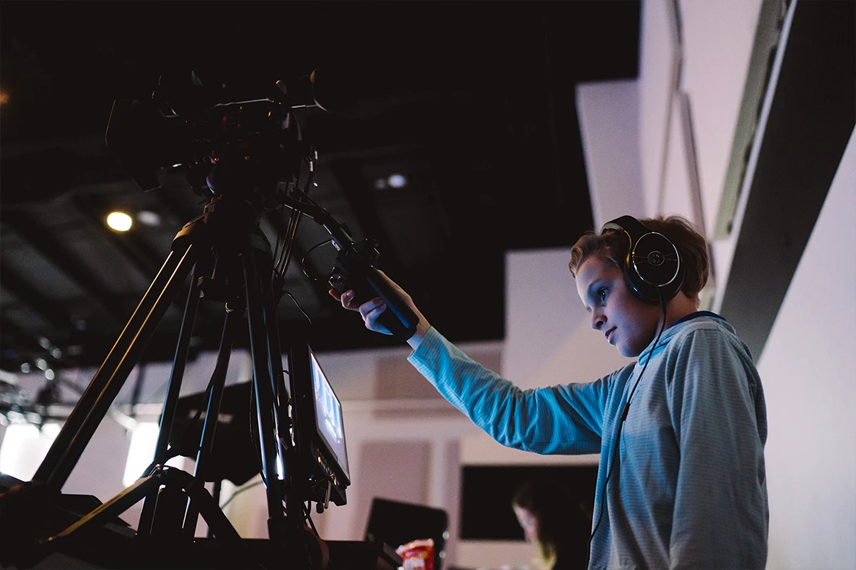 Young woman running a video camera.