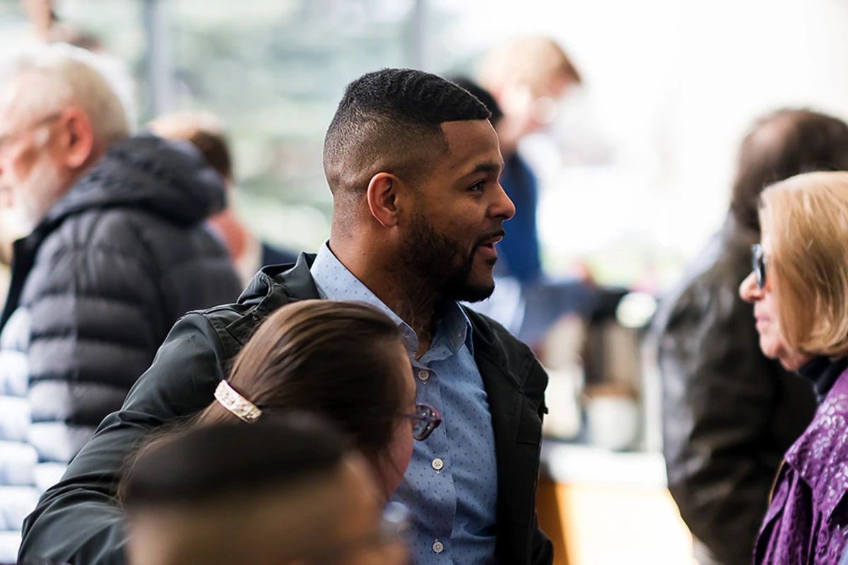 Women helping children at a registration table. Women helping children at a registration table.